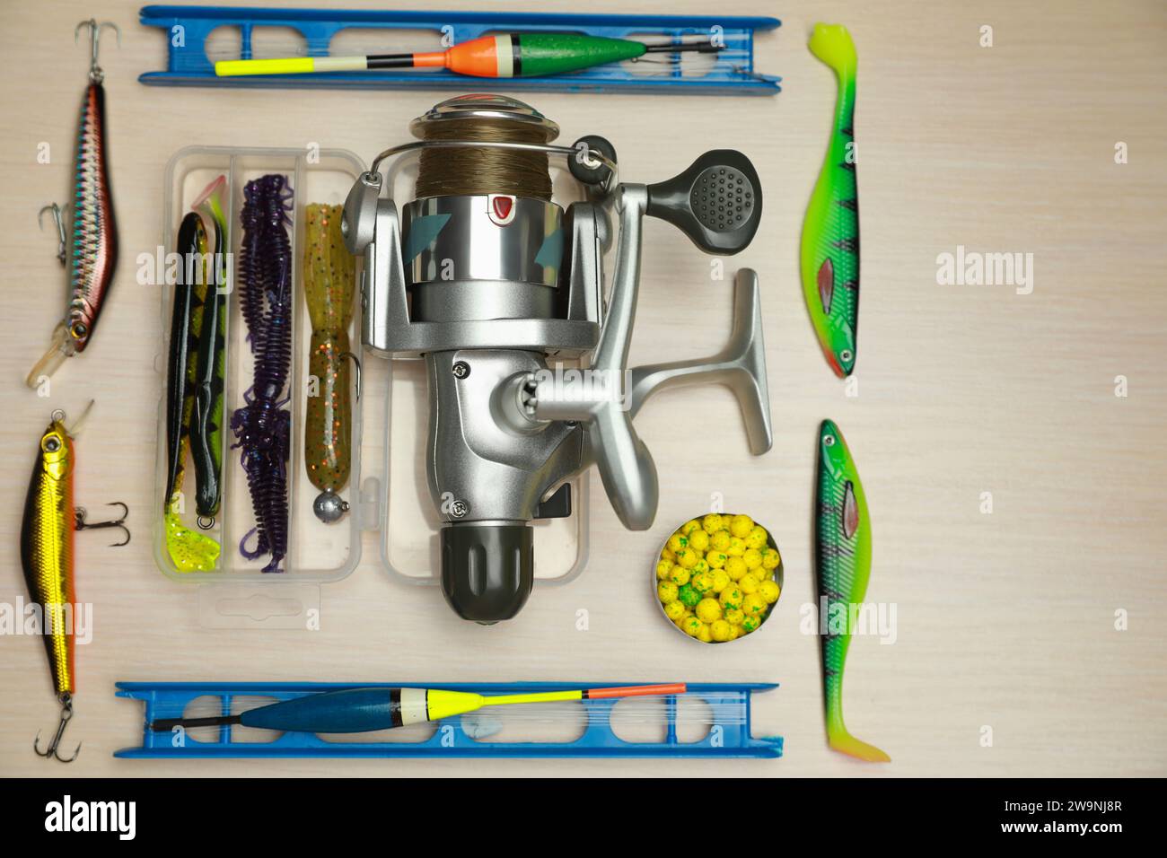 Fishing rod with a cortical handle and a fishing reel. A variety of floats.  Fishing bait from boilies and pellets. Vertical frame Stock Photo - Alamy