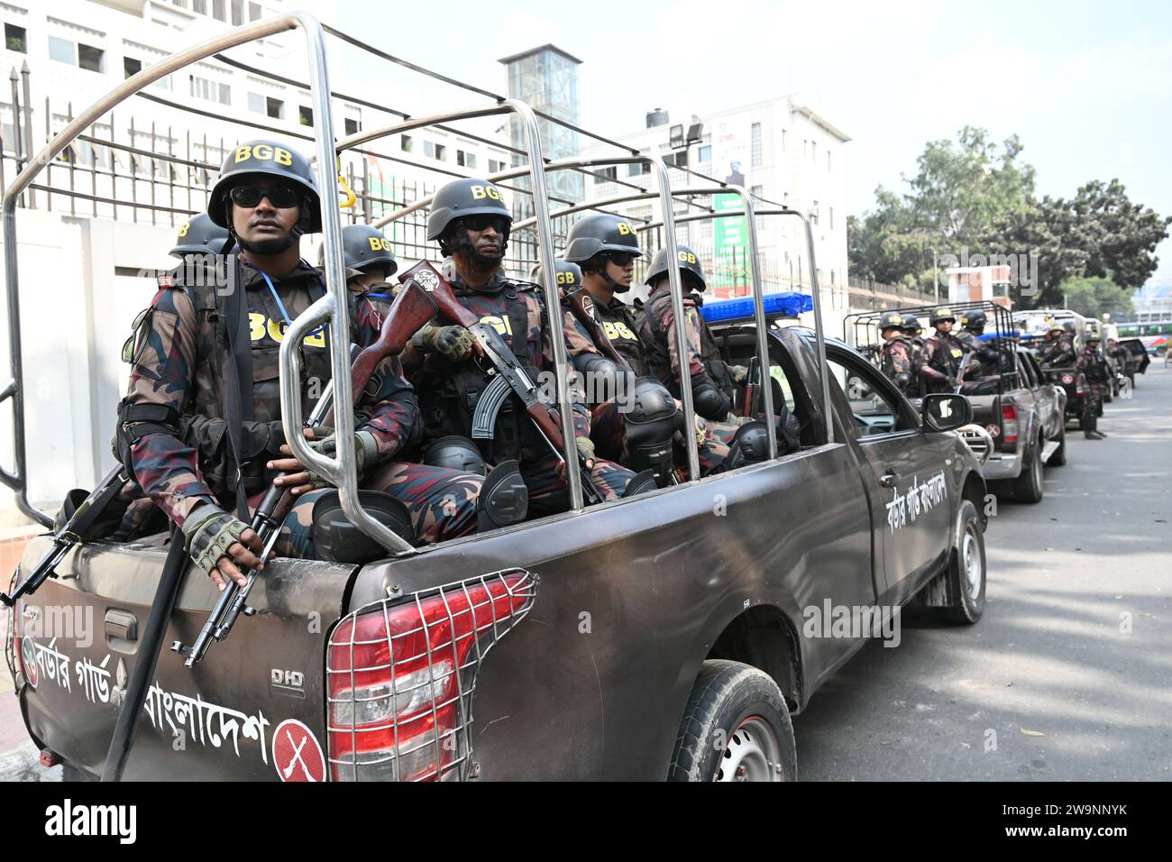 Members of Border Guard Bangladesh (BGB) stand guard in a street for the upcoming 12th general election in Dhaka, Bangladesh on December 29, 2023. Election security duties have started to help ensure a peaceful atmosphere and maintain law and order across the country for the 7 January polls. According to the Bangladesh Election Commission, the 12th general election is scheduled on 7 January 2024 to select members of the national parliament in Bangladesh. Stock Photo