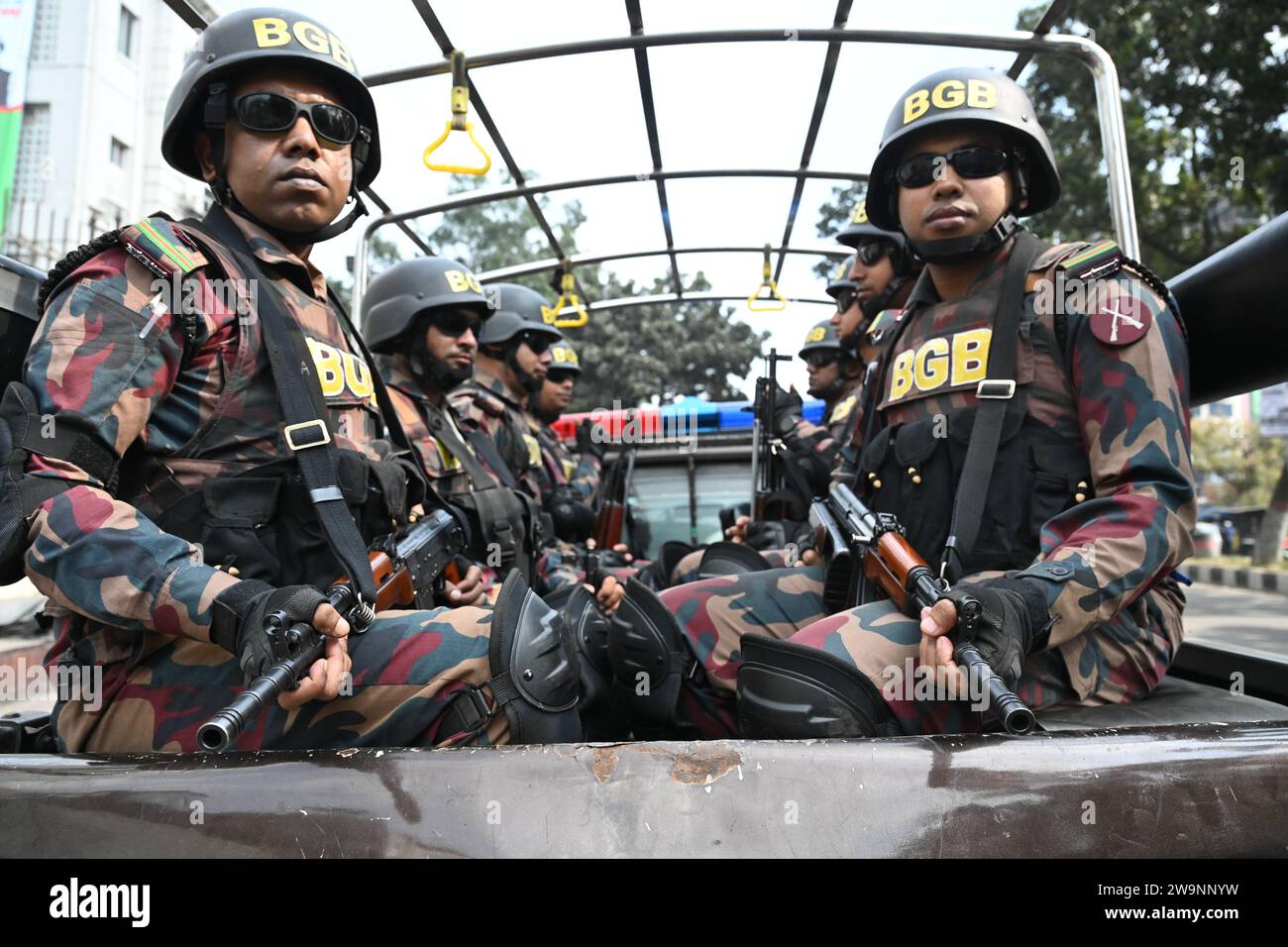 Members of Border Guard Bangladesh (BGB) stand guard in a street for the upcoming 12th general election in Dhaka, Bangladesh on December 29, 2023. Election security duties have started to help ensure a peaceful atmosphere and maintain law and order across the country for the 7 January polls. According to the Bangladesh Election Commission, the 12th general election is scheduled on 7 January 2024 to select members of the national parliament in Bangladesh. Stock Photo