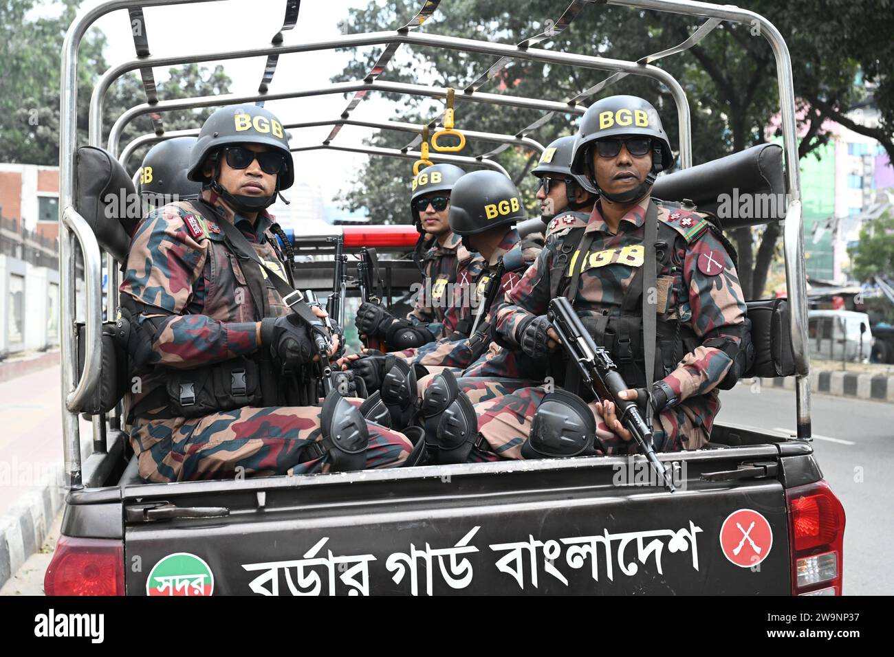 Members of Border Guard Bangladesh (BGB) stand guard in a street for the upcoming 12th general election in Dhaka, Bangladesh on December 29, 2023. Election security duties have started to help ensure a peaceful atmosphere and maintain law and order across the country for the 7 January polls. According to the Bangladesh Election Commission, the 12th general election is scheduled on 7 January 2024 to select members of the national parliament in Bangladesh. Stock Photo