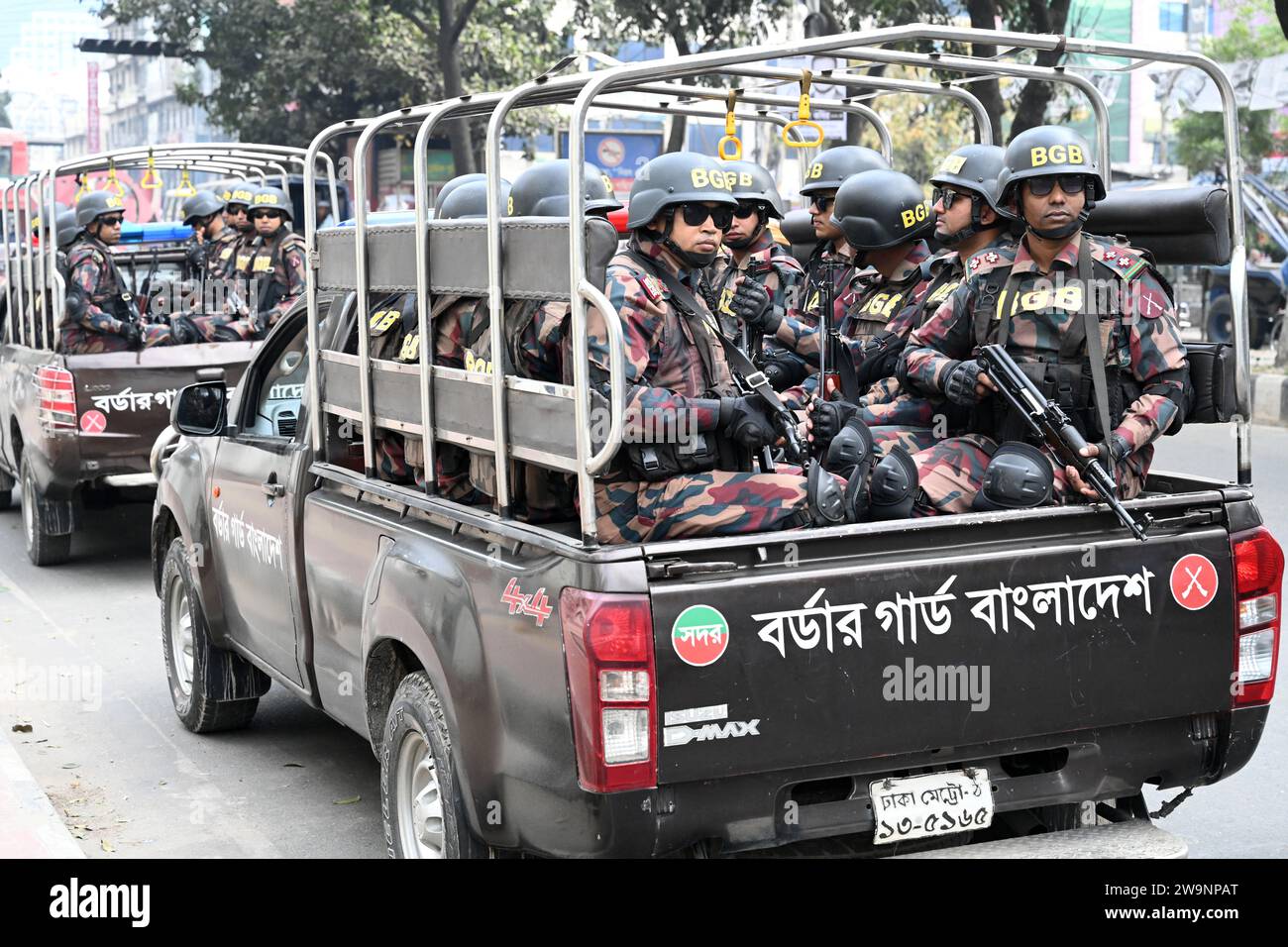 Members of Border Guard Bangladesh (BGB) stand guard in a street for the upcoming 12th general election in Dhaka, Bangladesh on December 29, 2023. Election security duties have started to help ensure a peaceful atmosphere and maintain law and order across the country for the 7 January polls. According to the Bangladesh Election Commission, the 12th general election is scheduled on 7 January 2024 to select members of the national parliament in Bangladesh. Stock Photo