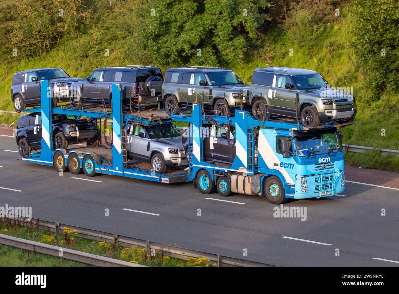 New 2023 Land Rovers, Grey Land Rover Defender Hard TOP D Mhev on ECM on car transporter; Bulk Haulage delivery trucks, collection and deliveries, lorry, transportation, truck, cargo, Mercedes-Benz vehicle, delivery, transport, industry, supply chain freight, on the M6 in Greater Manchester, UK Stock Photo