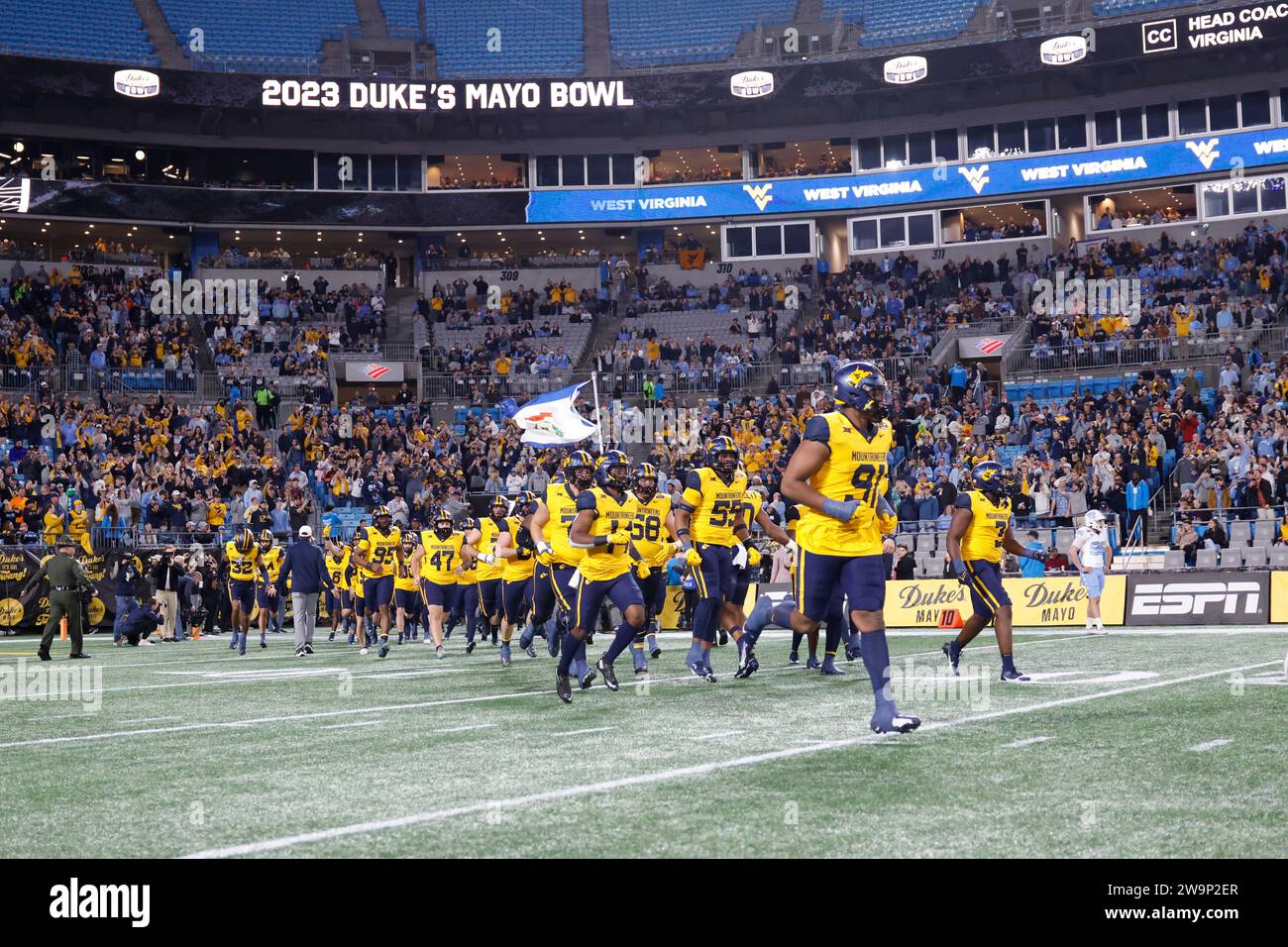 Dec 27, 2023; Charlotte, NC, USA;  West Virginia Mountaineers defensive lineman Sean Martin (91) leads his team to the field during the Duke’s Mayo Bo Stock Photo