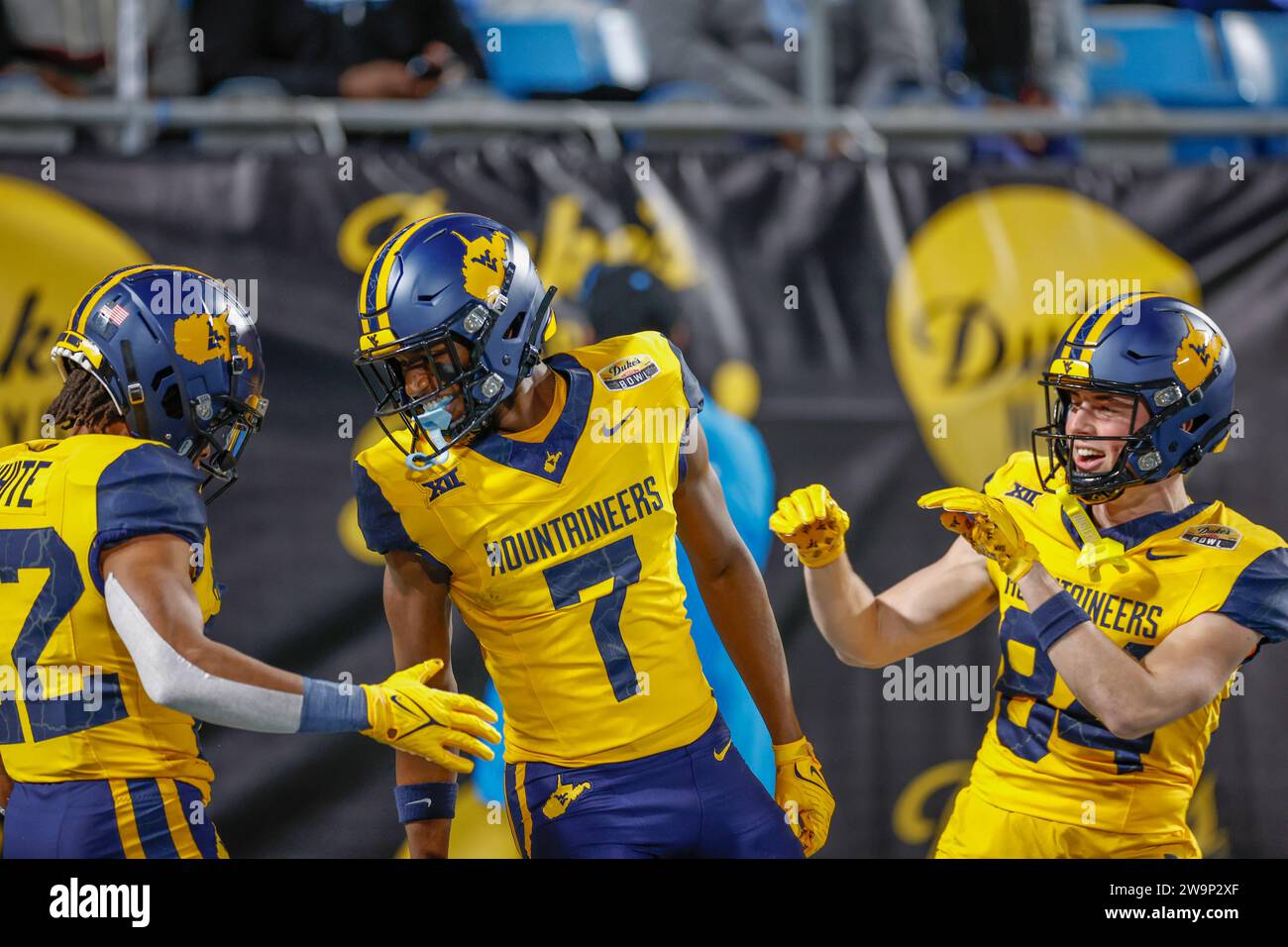 Dec 27, 2023; Charlotte, NC, USA;  West Virginia Mountaineers cornerback Andrew Wilson-Lamp (7) is congratulated by wide receiver Hudson Clement (84) Stock Photo