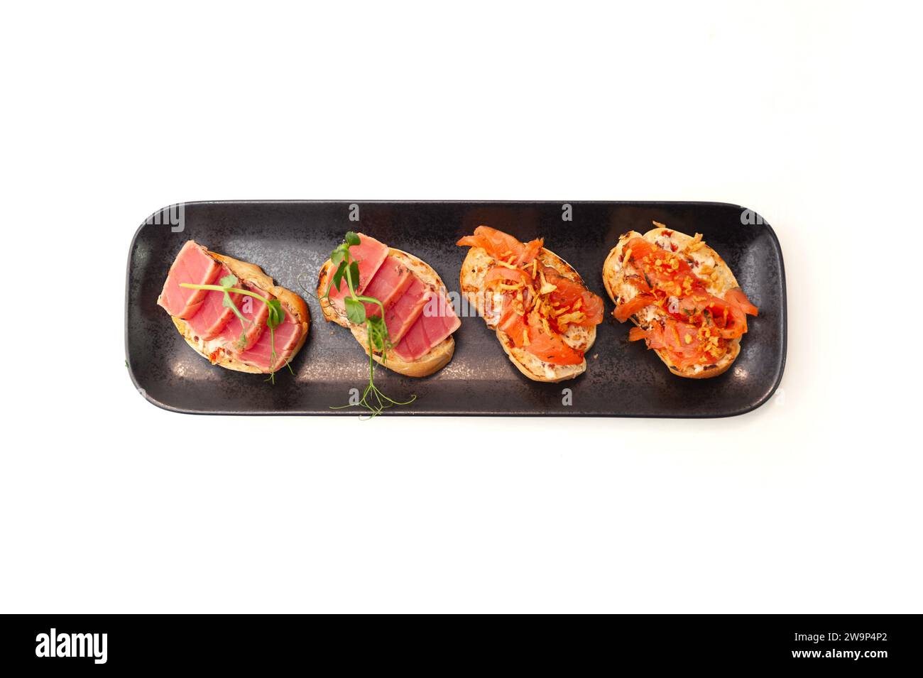 Bruschetta with salmon and tuna tartare on ciabatta toast isolated