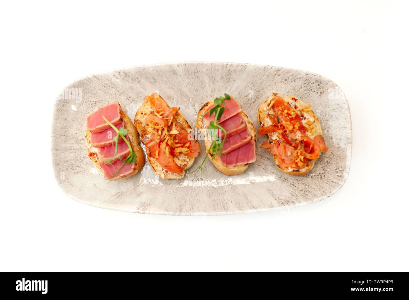 Bruschetta with salmon and tuna tartare on ciabatta toast isolated