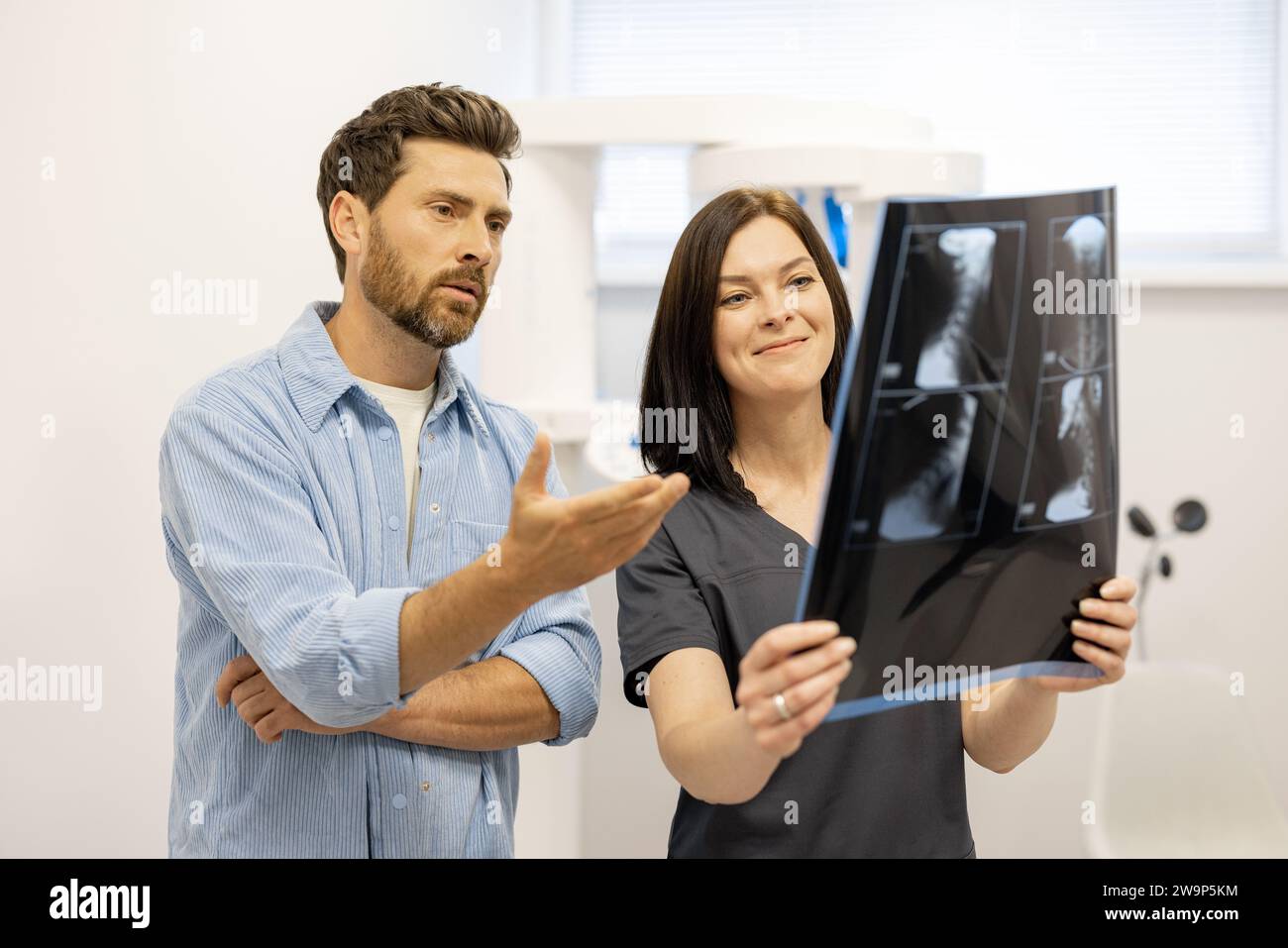male patient looks on x-ray of the cervical spine with a doctor Stock Photo