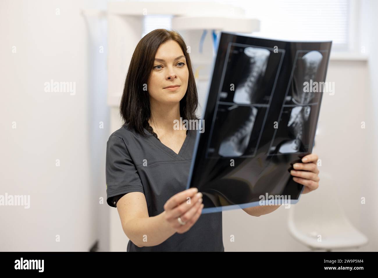 Doctor examines an x-ray of the cervical spine Stock Photo