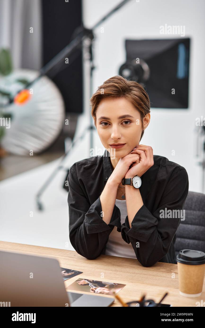young attractive woman in casual attire sitting at desk in her photo ...