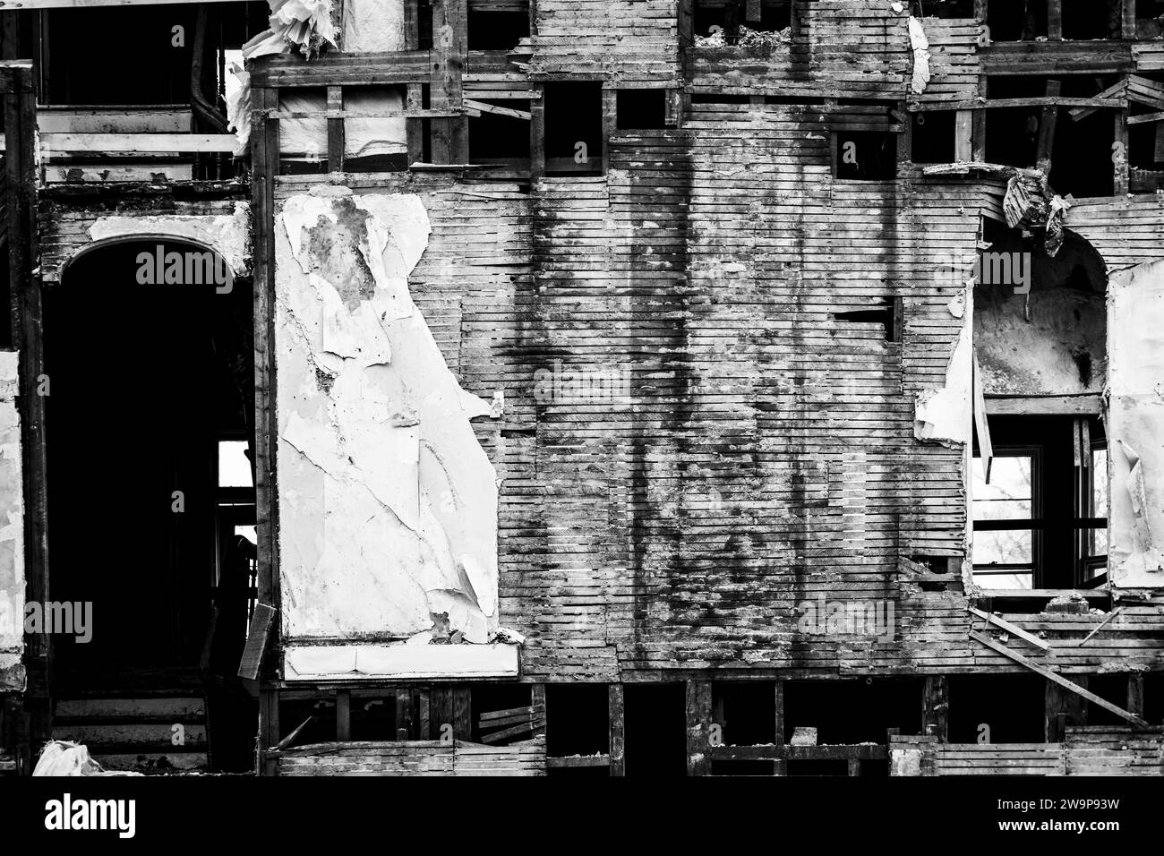 Exposed wall structure and construction of an old house undergoing partial demolition. Stock Photo