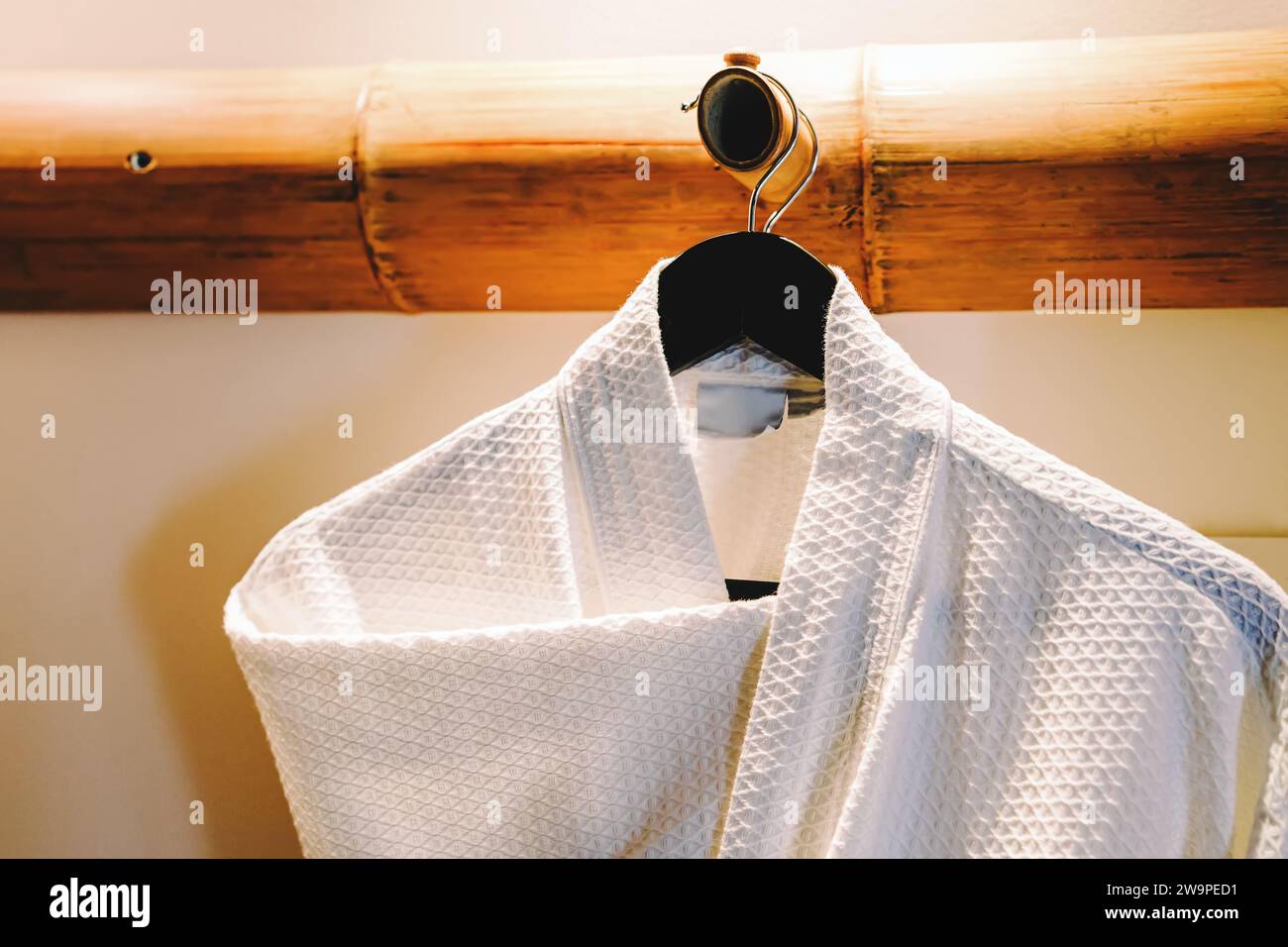 Cozy waffle cotton bathrobe on the hanger close-up Stock Photo