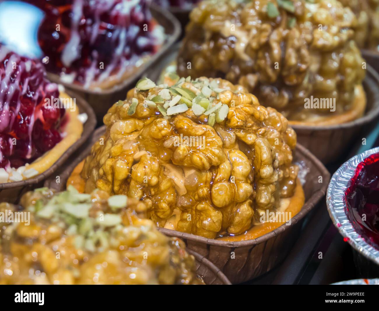 Small cake garnished with walnuts Stock Photo
