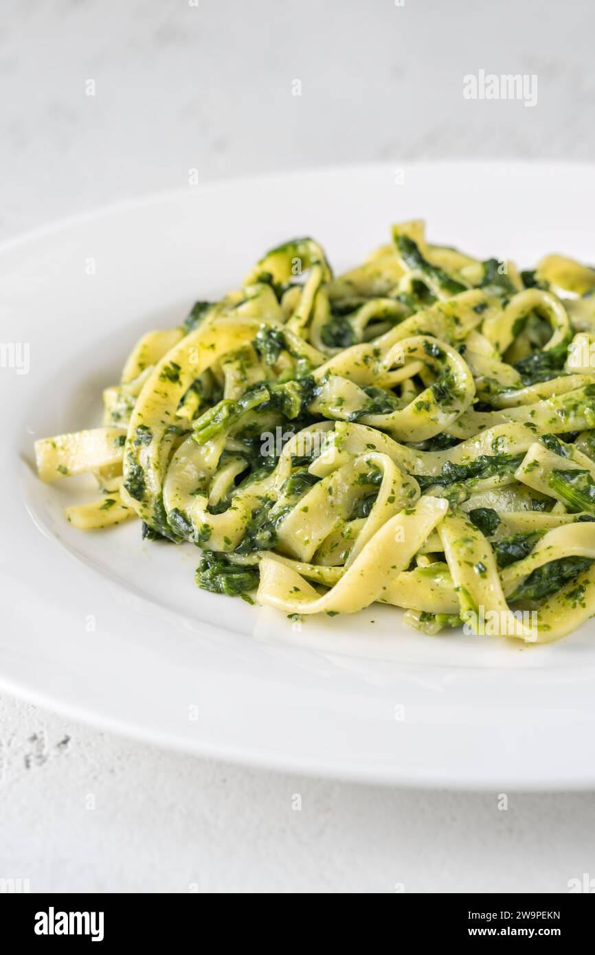 Creamy spinach tagliatelle pasta on the plate Stock Photo