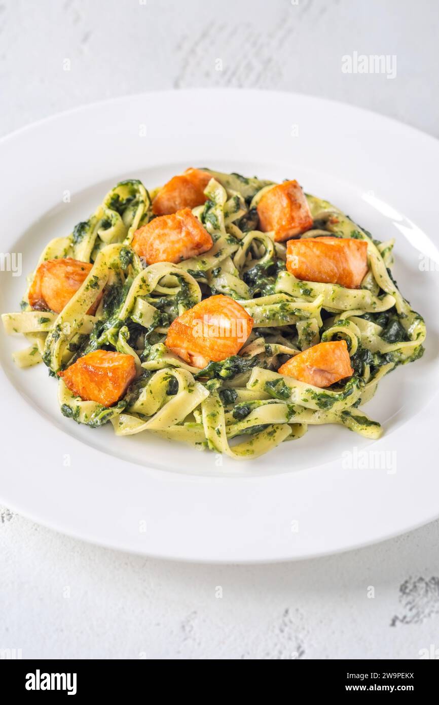 Portion of creamy spinach pasta with salmon Stock Photo