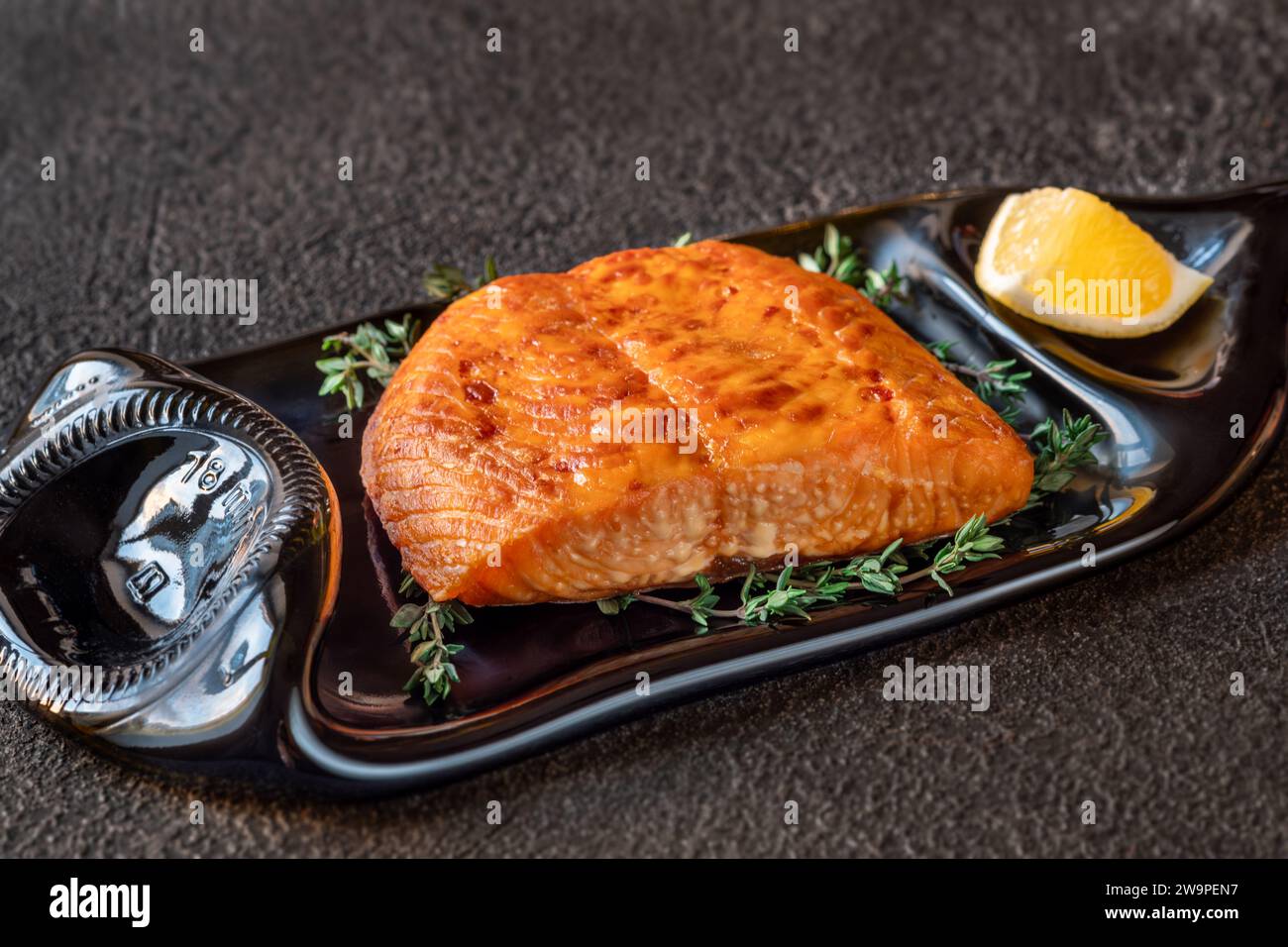 Portion of baked salmon fillet with thyme and lemon Stock Photo