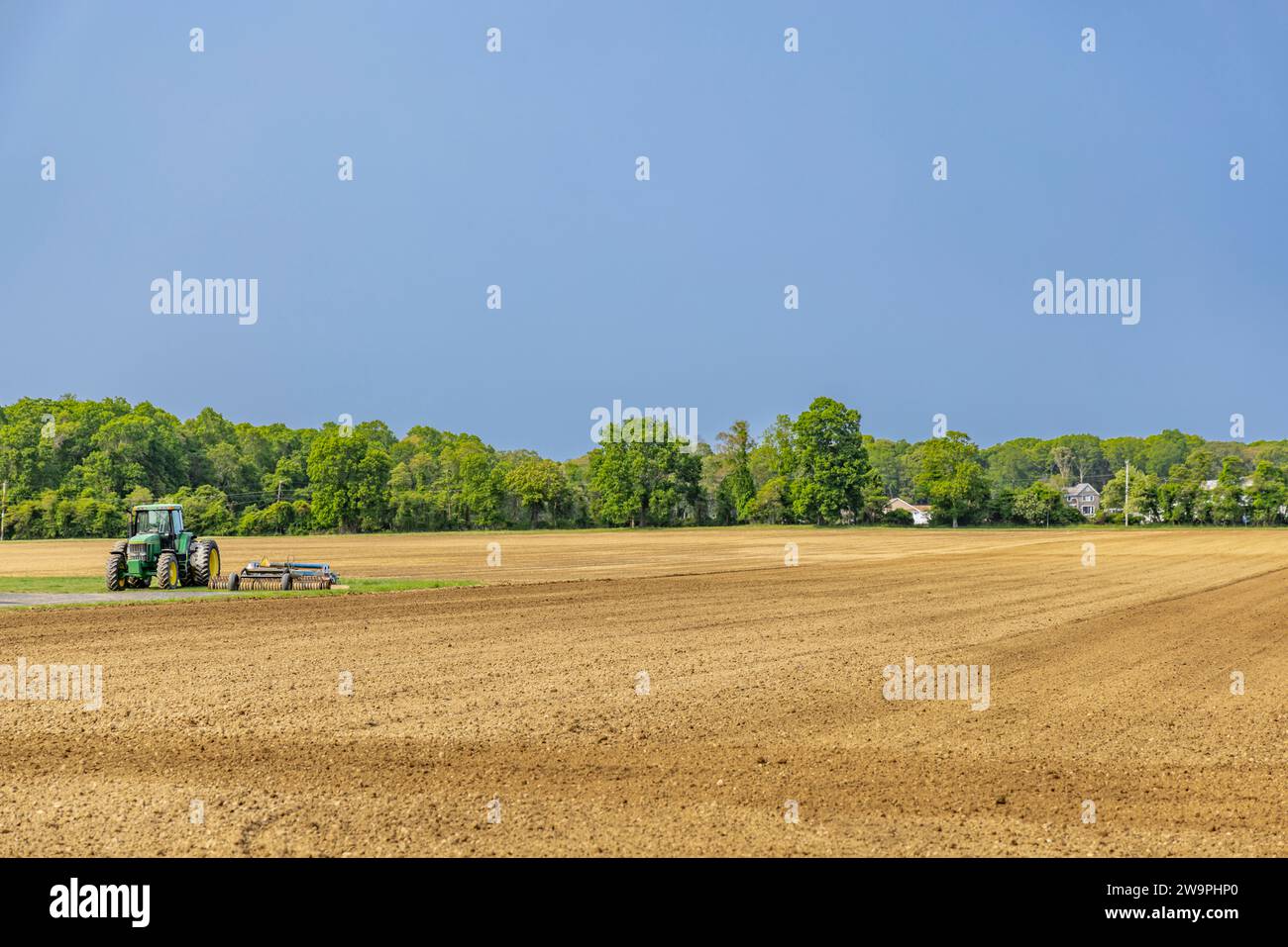 john deere tractor sitting in a freshly plowed field Stock Photo - Alamy