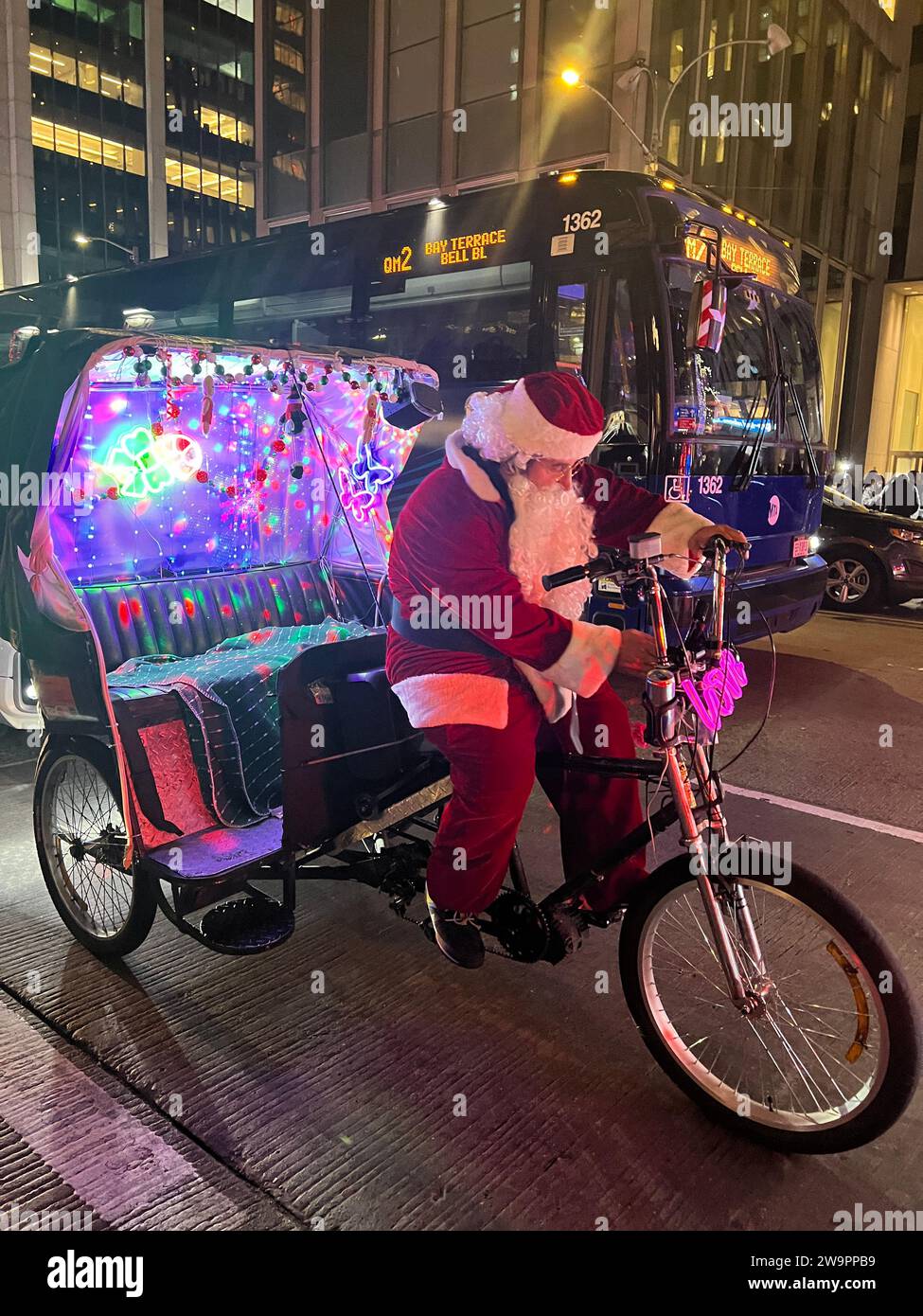 Pedicab driver dressed in the spirit of the Christmas holiday season on 6th Avenue in midtown Manhattan. Stock Photo