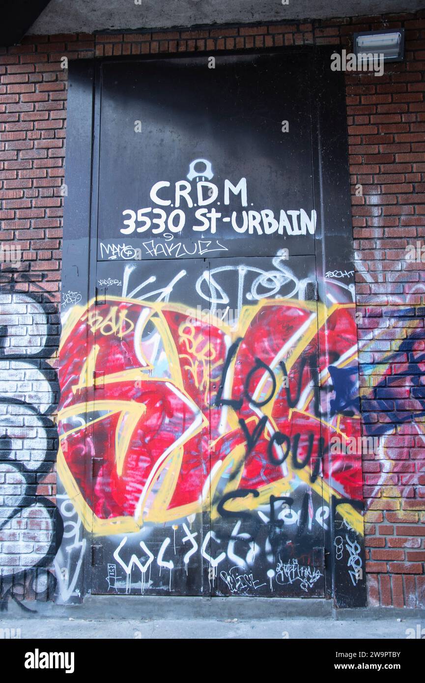 Graffiti on door of CRDM on St. Urbain Street in downtown Montreal