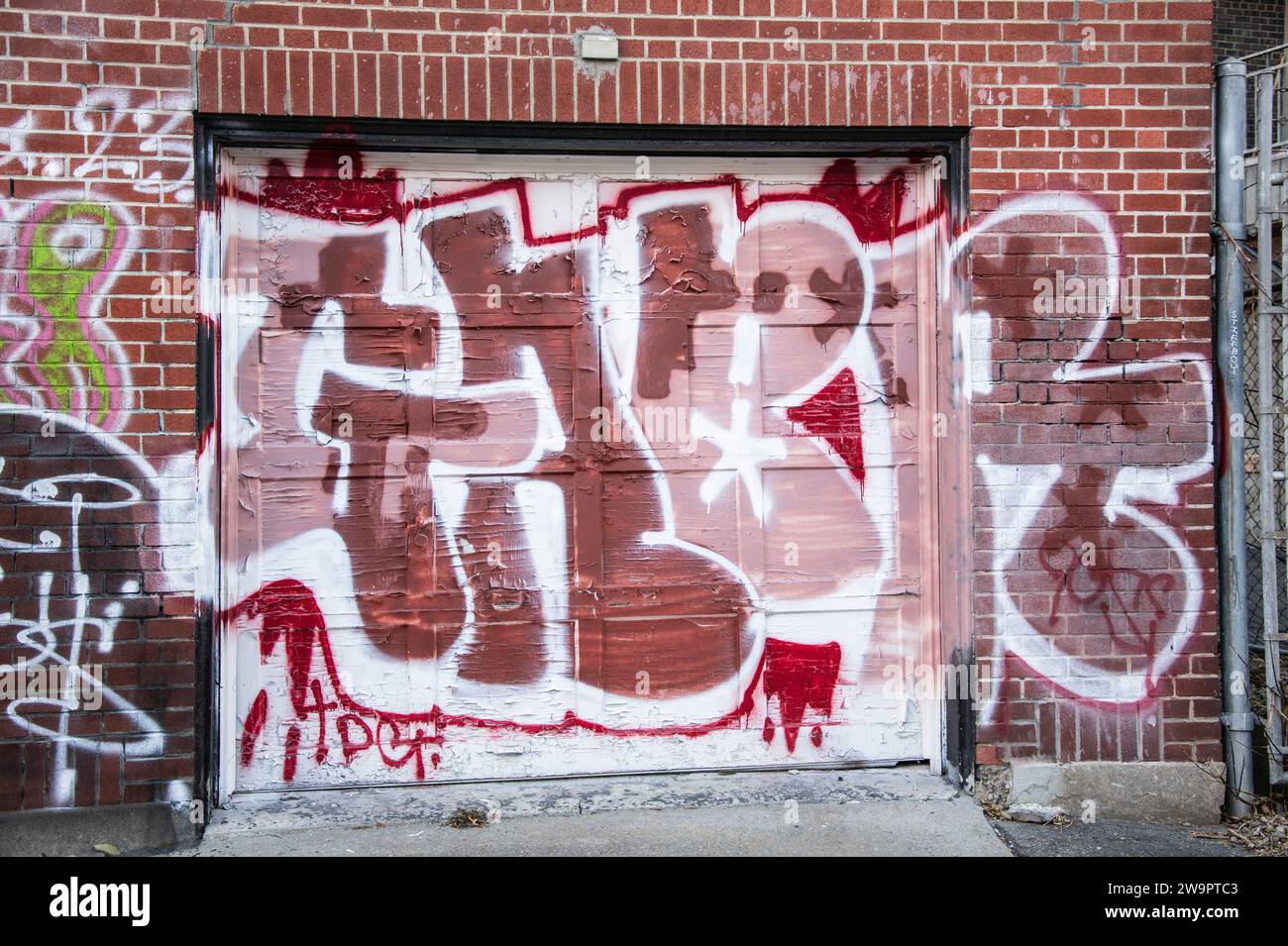 Graffiti on garage roll up door in downtown Montreal, Quebec, Canada Stock Photo