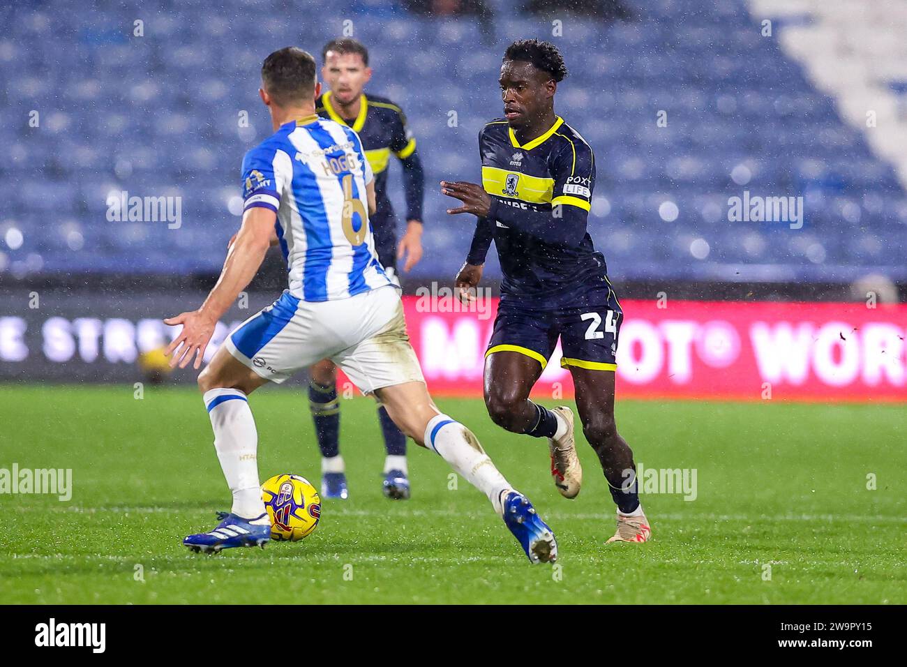 Alex Bangura #24 of Middlesbrough runs through the Huddersfield Town defence during the Sky Bet Championship match Huddersfield Town vs Middlesbrough at John Smith's Stadium, Huddersfield, United Kingdom, 29th December 2023  (Photo by Ryan Crockett/News Images) Stock Photo