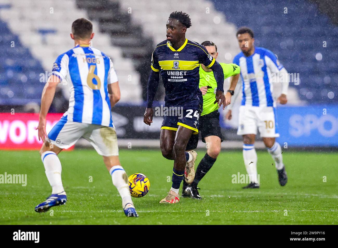 Alex Bangura #24 of Middlesbrough runs through the Huddersfield Town defence during the Sky Bet Championship match Huddersfield Town vs Middlesbrough at John Smith's Stadium, Huddersfield, United Kingdom, 29th December 2023  (Photo by Ryan Crockett/News Images) Stock Photo
