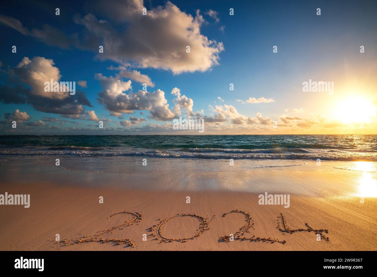 Happy New Year 2024 Concept Lettering On The Beach Written Text On   Happy New Year 2024 Concept Lettering On The Beach Written Text On The Sea Beach At Sunrise 2W9R367 