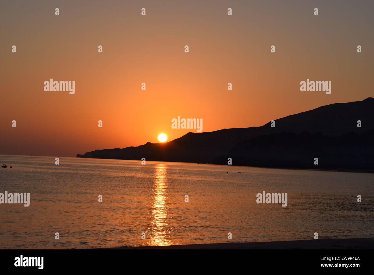 The sky is ablaze with color as the sun rises over the horizon. Stock Photo