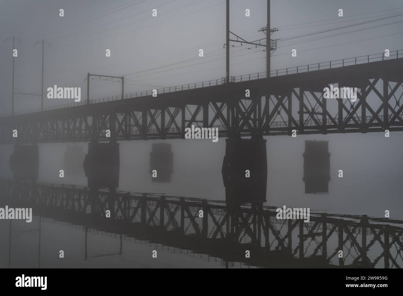 Railroad Bridge Reflections on a Foggy Night, Havre de Grace MD USA Stock Photo