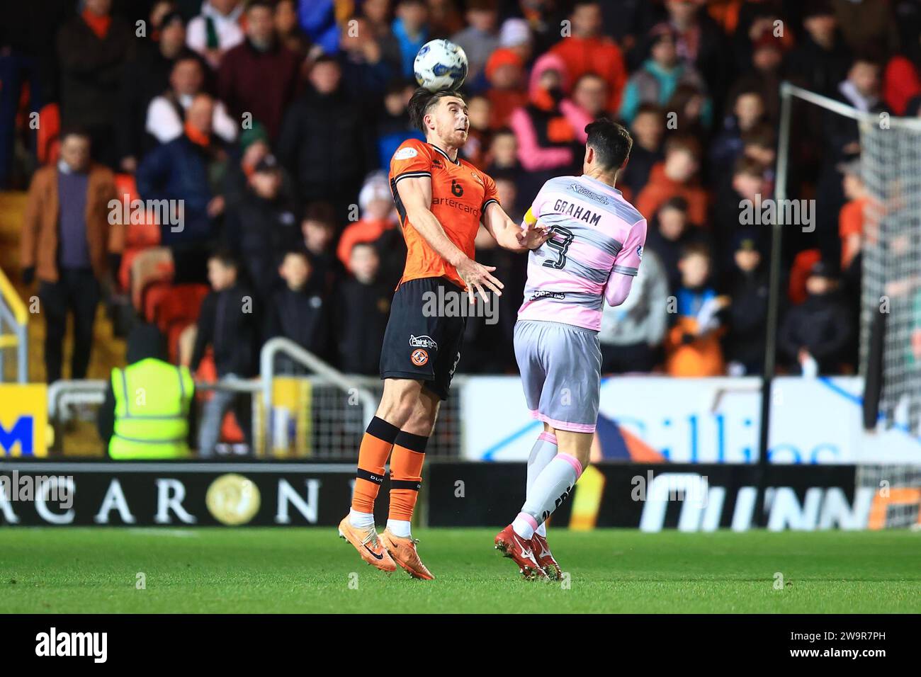 29th December 2023; Tannadice Park, Dundee, Scotland: Scottish Championship Football, Dundee United versus Partick Thistle; Declan Gallagher of Dundee United competes in the air with Brian Graham of Partick Thistle Credit: Action Plus Sports Images/Alamy Live News Stock Photo
