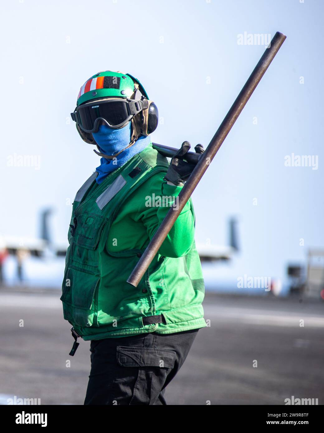 Aviation BoatswainÕs Mate (Equipment) 2nd Class Sarah Roberts, assigned to the air department of the worldÕs largest aircraft carrier USS Gerald R. Ford (CVN 78), carries a push bar on the flight deck during routine flight operations, Nov. 30, 2023. The Gerald R. Ford Carrier Strike Group is currently operating in the Mediterranean Sea. The U.S. maintains forward-deployed, ready, and postured forces to deter aggression and support security and stability around the world. (U.S. Navy photo by Mass Communication Specialist 3rd Class Simon Pike) Stock Photo