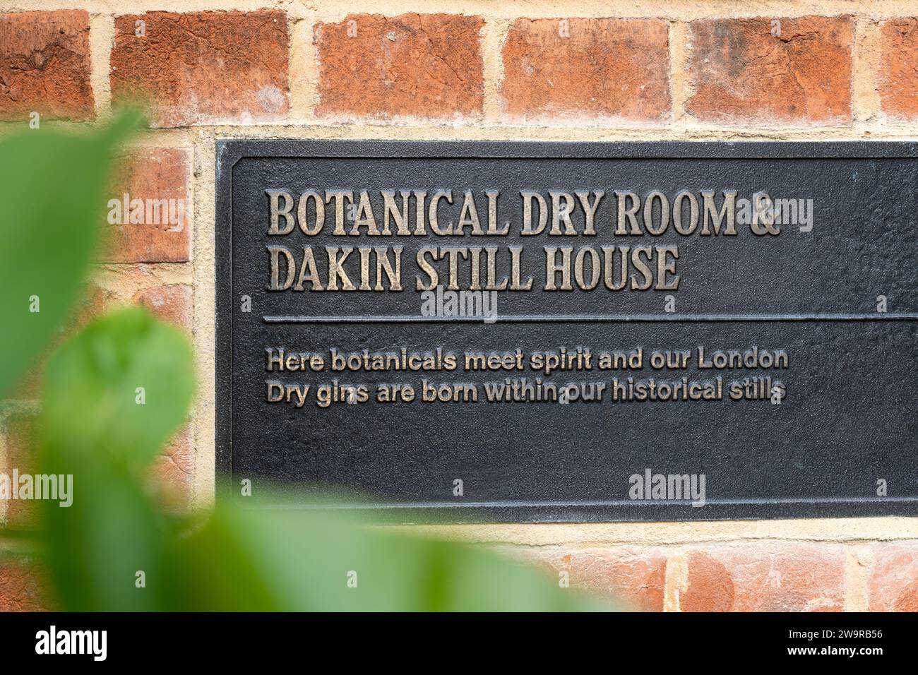 A metal plaque reading 'Botanical Dry Room and Dakin Still House' at Laverstoke Mill - Bombay Sapphire distillery - a gin distillery in Hampshire, UK Stock Photo