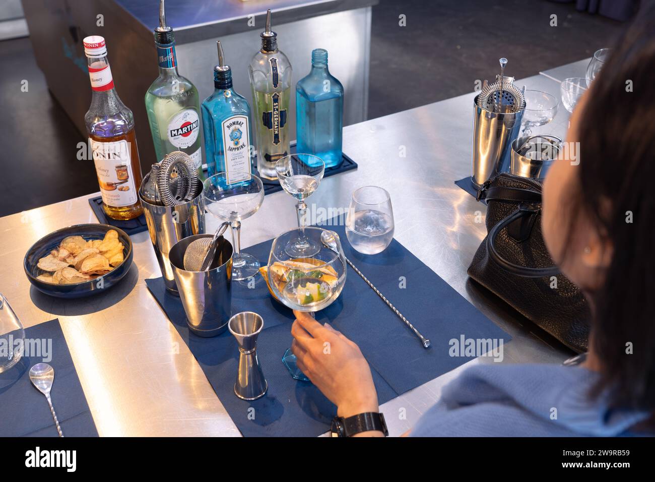 Visitor to Bombay Sapphire distillery mixing a gin and tonic cocktail