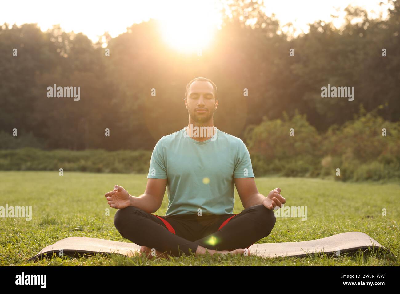 Portrait man practicing yoga meditating hi-res stock photography and ...