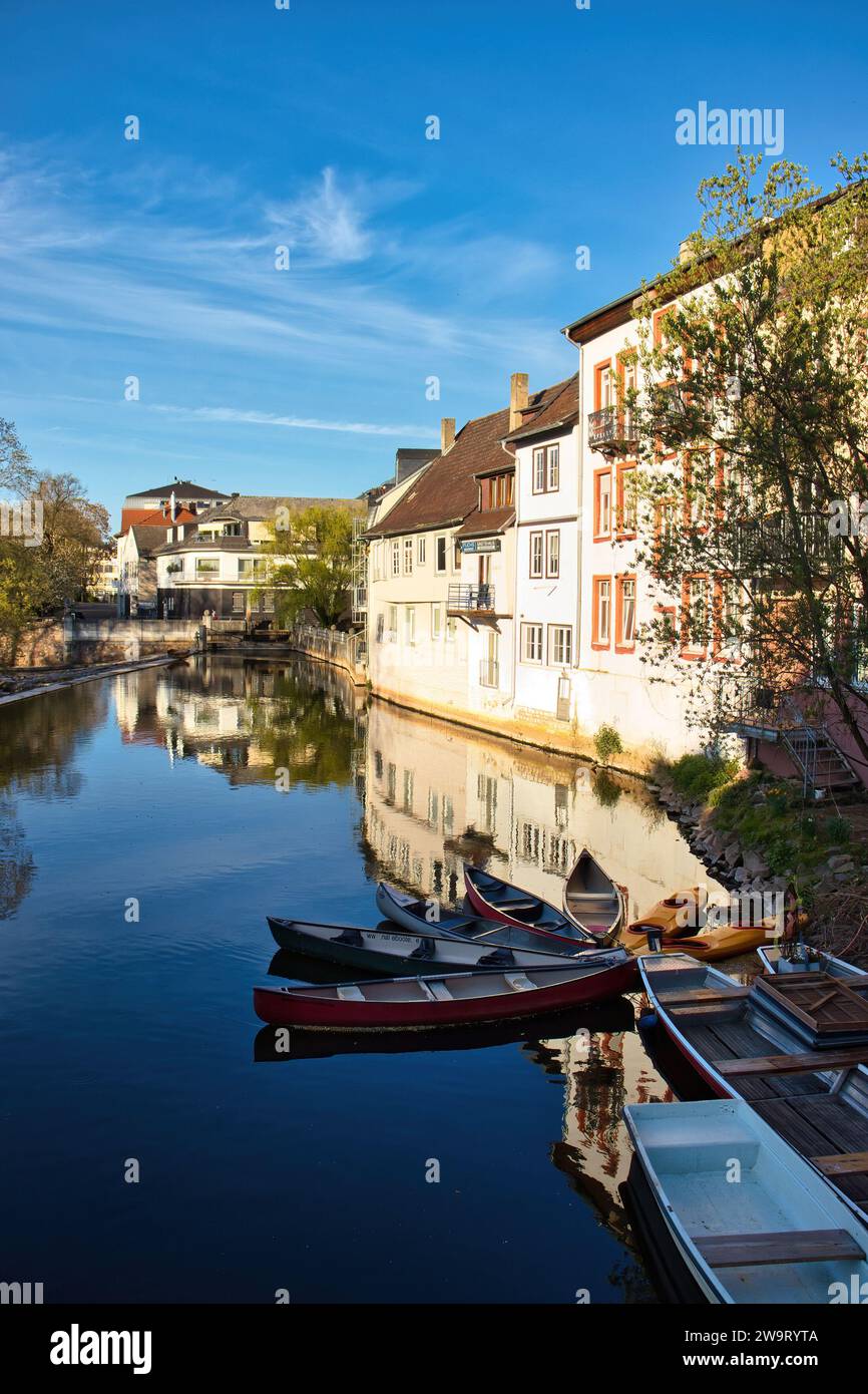 Bad Kreuznach, Germany - April 25, 2021: Small boats in the Nahe River with buildings and their reflections in the background on a spring day in Bad K Stock Photo