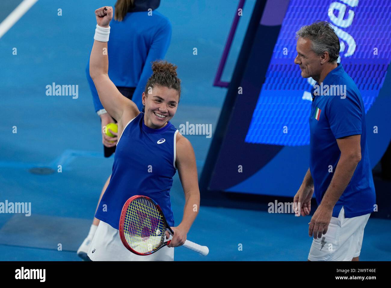 Italy's team captain Renzo Furlan, right, watches as Jasmine Paolini
