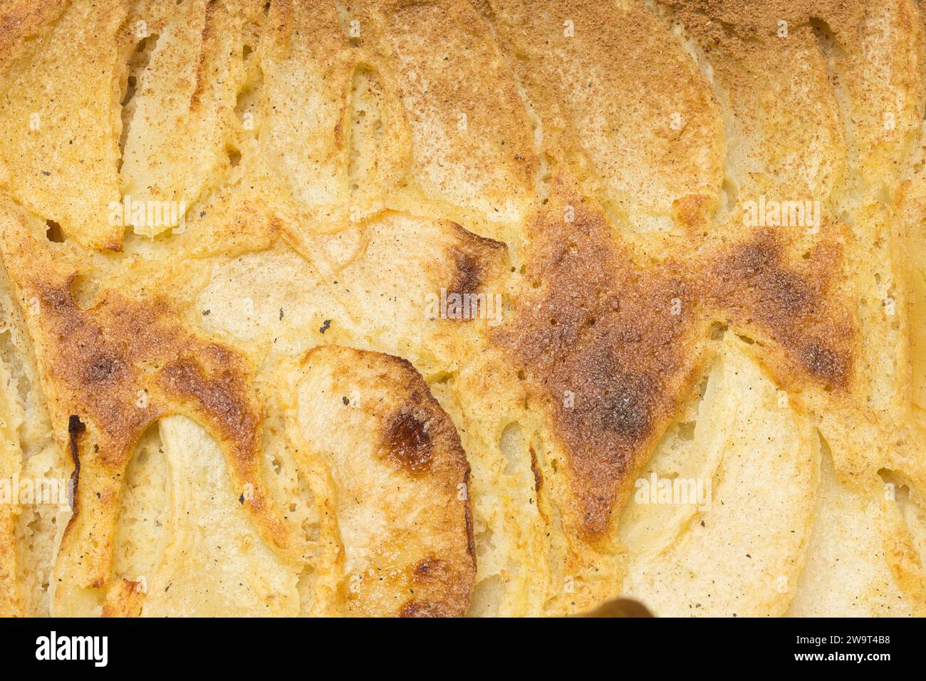A close-up of the top crust of a perfectly baked apple pie with the crust is beautifully golden brown. Home-made dessert and healthy dessert options w Stock Photo