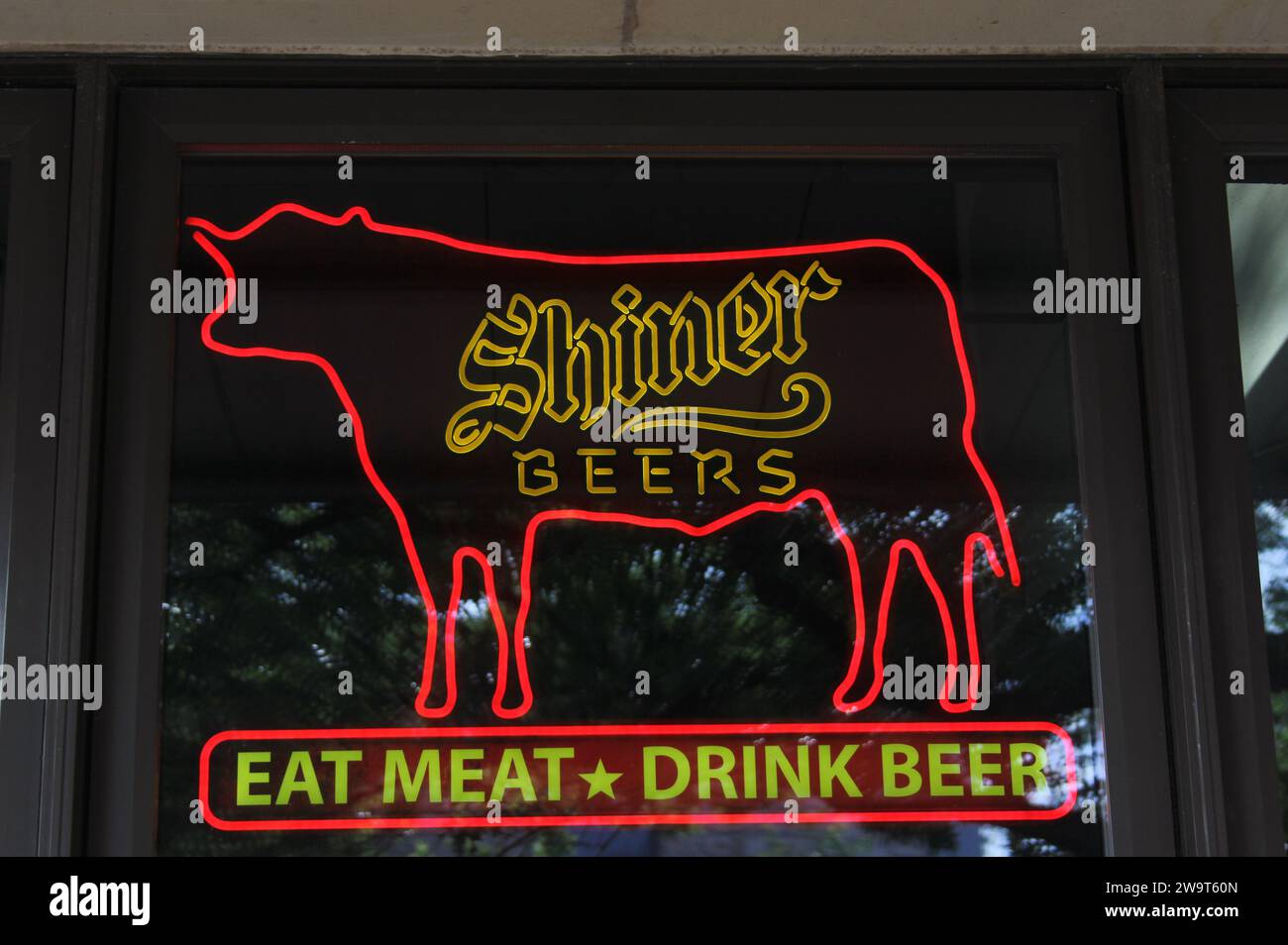 Georgetown TX: June 7, 2023 - Regionally Brewed Shiner Bock Beer Sign in Downtown Georgetown TX Window Stock Photo