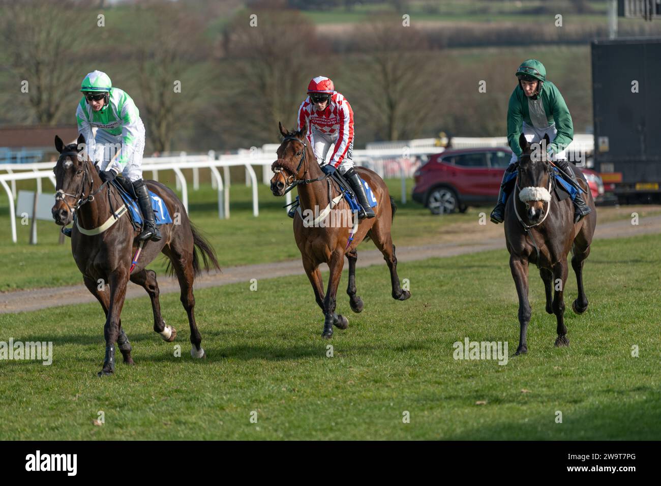 Instant Gambler, Big Bill Newman and Blakey Bear canter to the start at Wincanton on March 21st 2022 Stock Photo