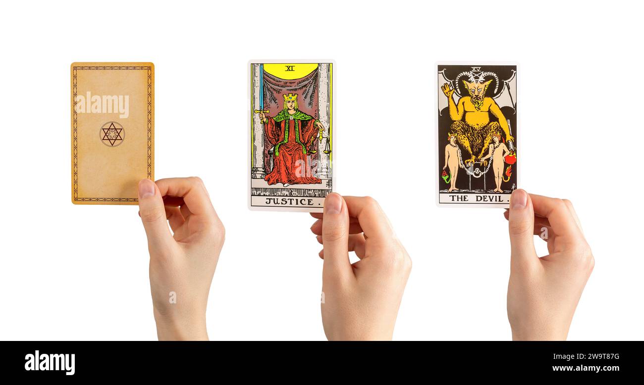Berlin, Germany July 15 2023 Devil and Justice, major tarot card and reverse side in hand isolated on white background Stock Photo