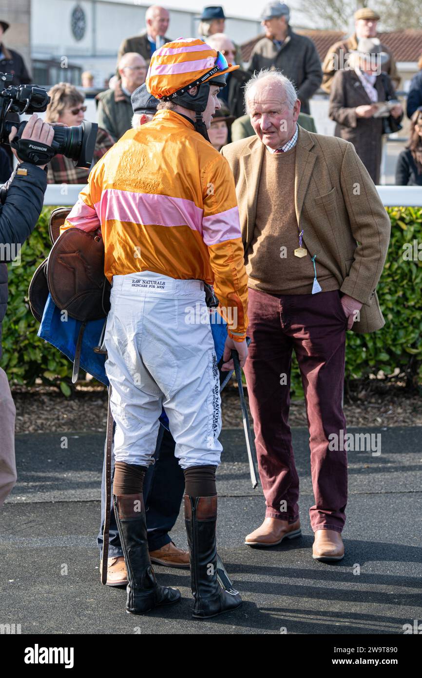 Name in Lights with jockey Brendan Powell and groom Richie in winner's position in the post race parade for the fourth race at Wincanton, March 21st 2 Stock Photo