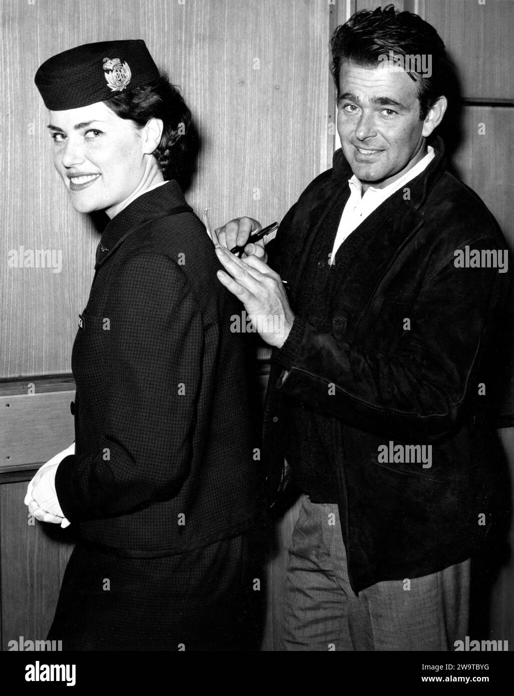 STUART WHITMAN signing autograph with B.E.A. Airline Stewardess at London Airport in 1960 on his arrival to appear in the film THE MARK 1961 director GUY GREEN novel Charles Israel screenplay Sidney Buchman and Stanley Mann Buckman / Raymond Stross Productions / Twentieth Century Fox Film Company Stock Photo