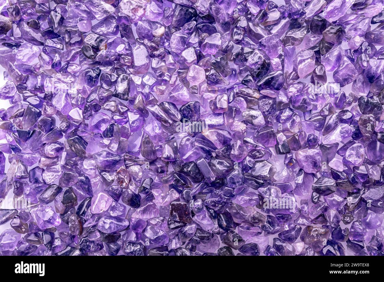 amethyst stone chips macro detail texture background. close-up polished semi-precious gemstone. Stock Photo