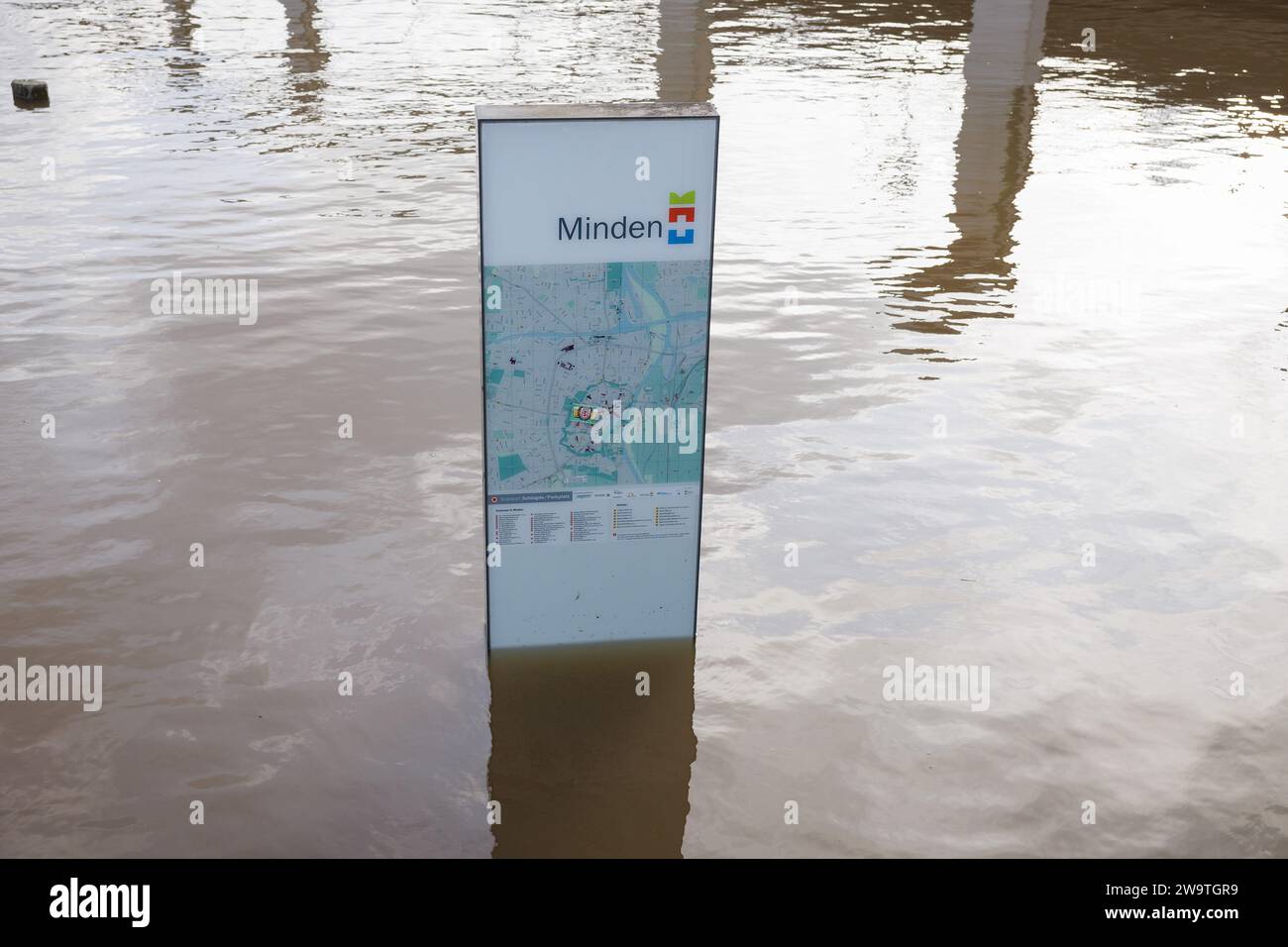Minden, Germany. 30th Dec, 2023. View of a Steele washed by water with the city map of Minden on the banks of the Weser. Despite a slight easing of water levels, numerous streams and rivers in North Rhine-Westphalia continue to flood. Credit: Friso Gentsch/dpa/Alamy Live News Stock Photo