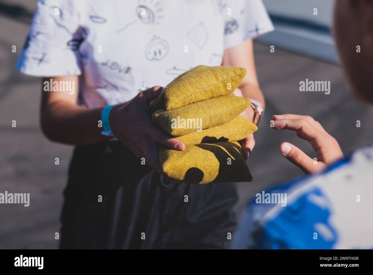 Cornhole game set, process of throwing bean bags, kids children tossing ...