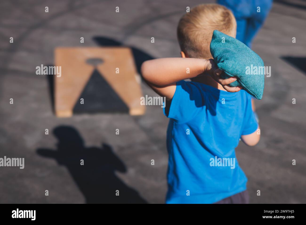 Cornhole game set, process of throwing bean bags, kids children tossing ...