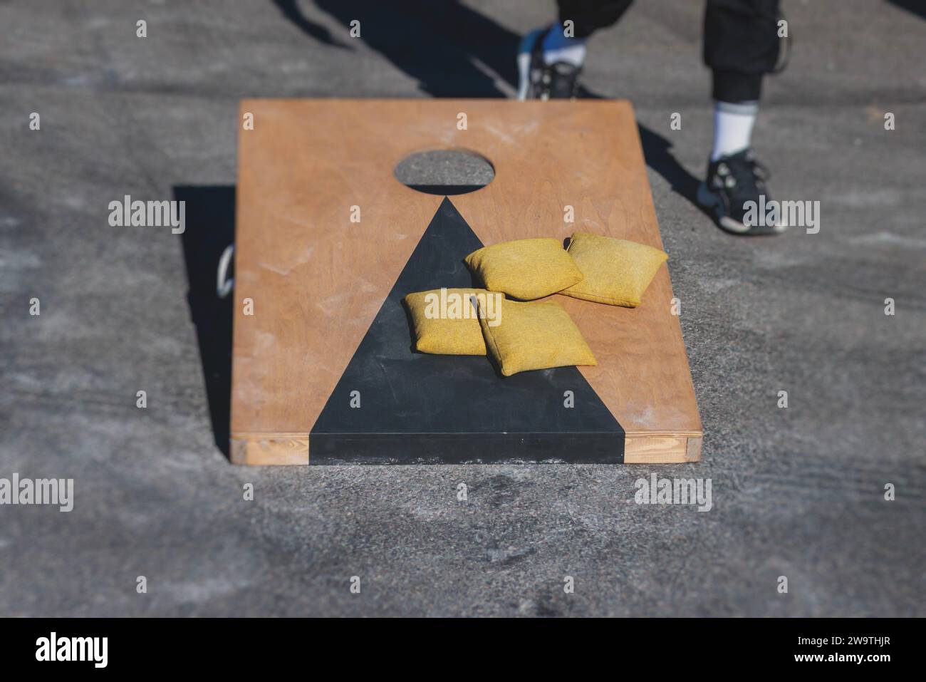 Cornhole game set, process of throwing bean bags, kids children tossing
