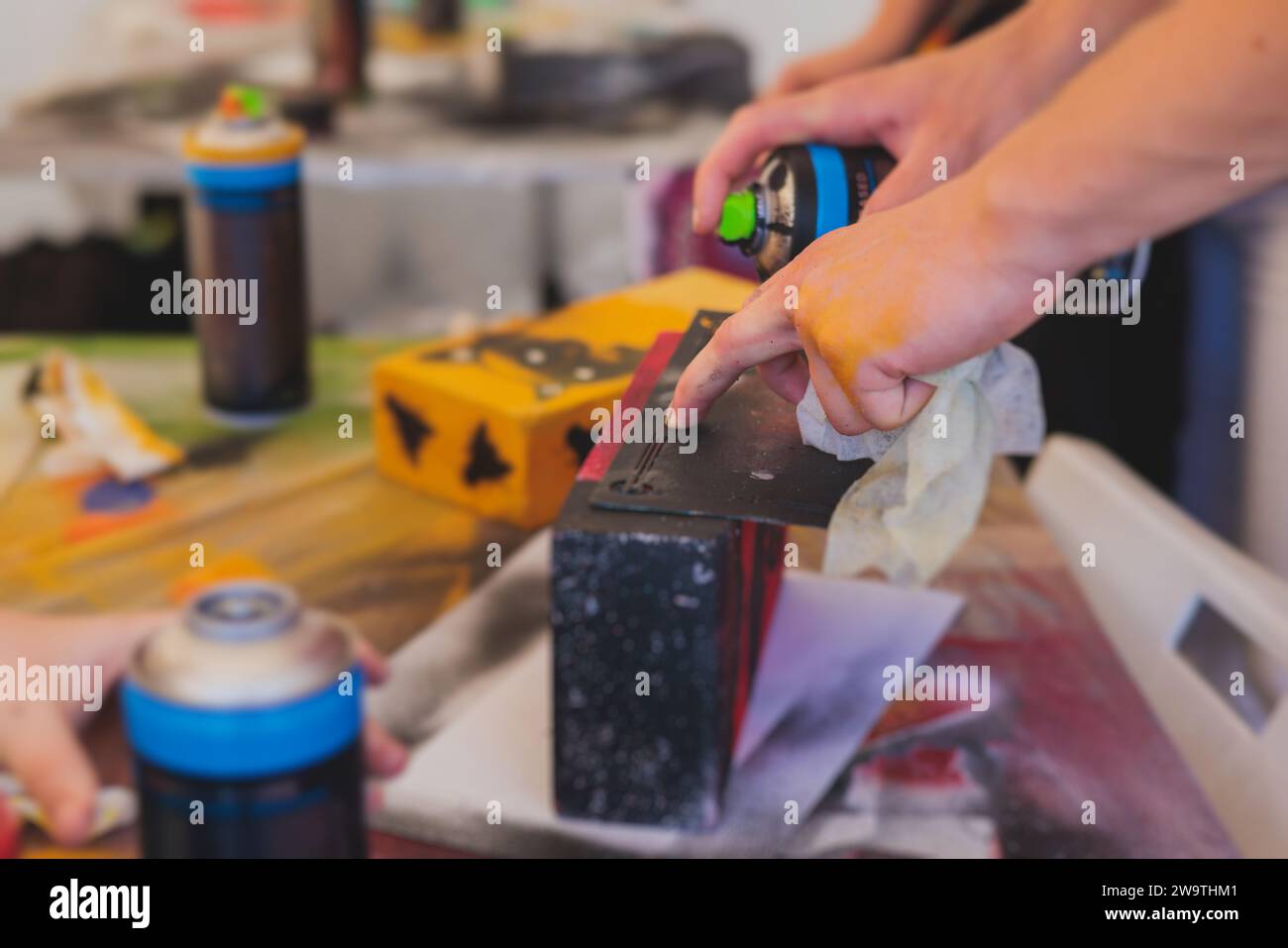 Process of creating graffiti, street artist with aerosol spray paint ...