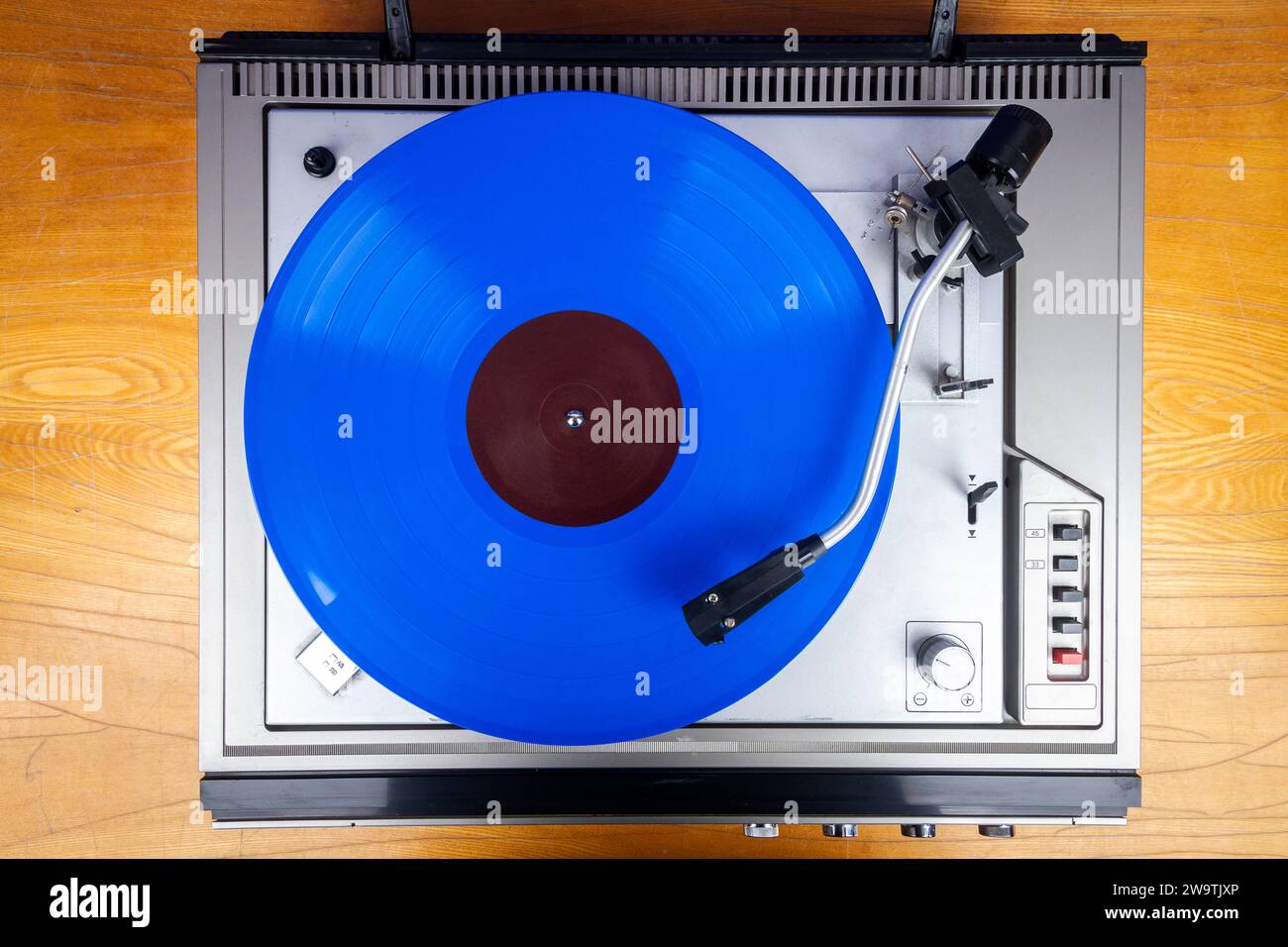 Vintage turntable vinyl record player with blue vinyl on a table Stock ...