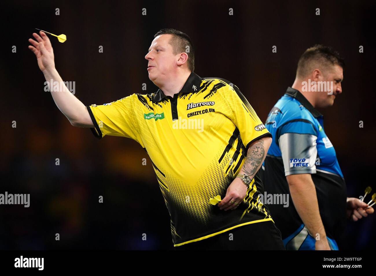 Dave Chisnall in action against Daryl Gurney (not pictured) on day thirteen of the Paddy Power World Darts Championship at Alexandra Palace, London. Picture date: Saturday December 30, 2023. Stock Photo