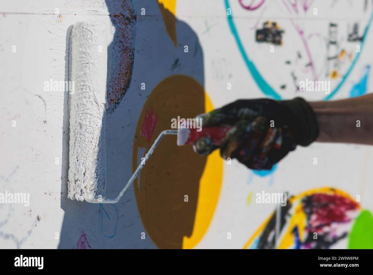 Process of creating graffiti, street artist with aerosol spray paint ...